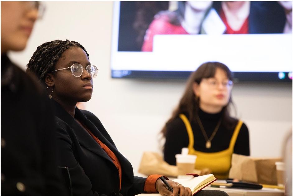 Barnard students in a panel discussion listening to a speaker